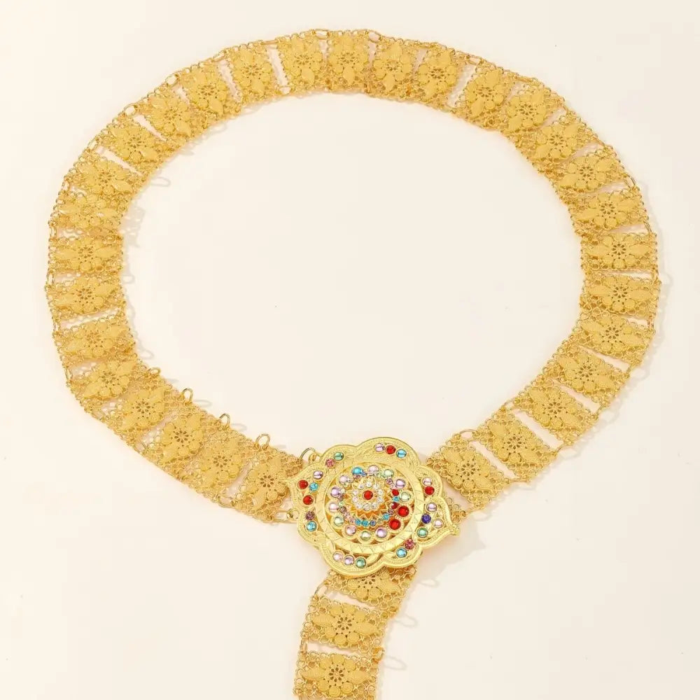 Gold-tone metal belt with floral embellishments and jeweled flower buckle