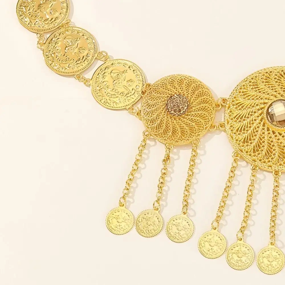 Gold-toned coin and intricately designed filigree waist belt displayed in the product image