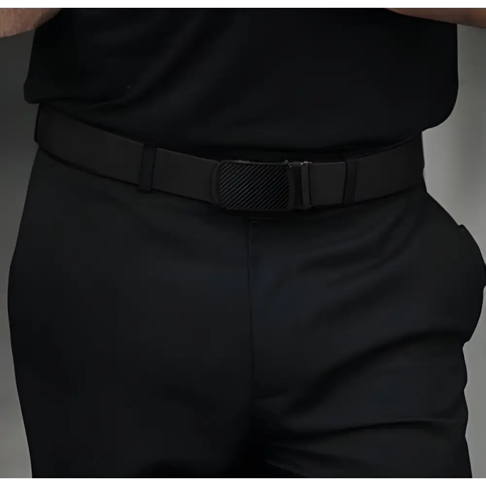 Black elastic belt with textured buckle paired with Khaki Pants featuring white and black belts