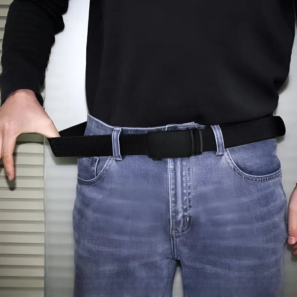 Black elastic belt with textured buckle displayed with Khaki Pants and white belt