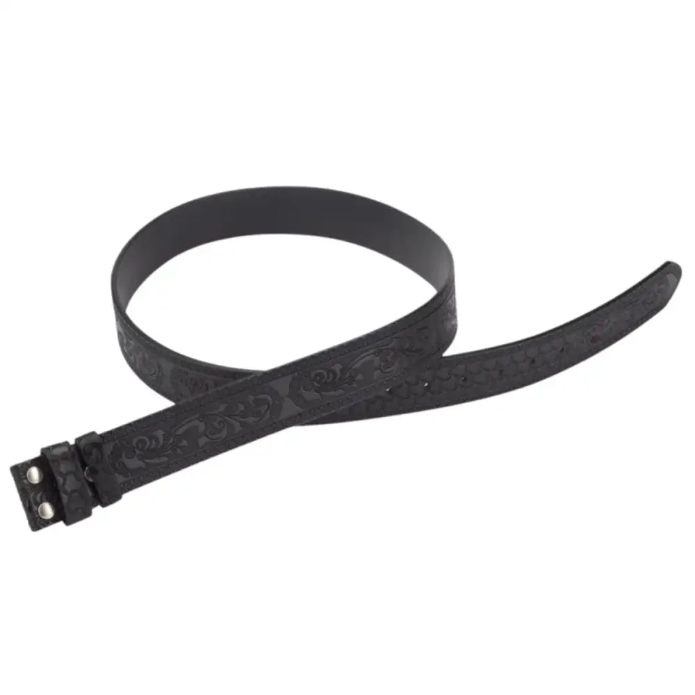 Black patterned leather belt displayed alongside a matching ashtray in a stylish set