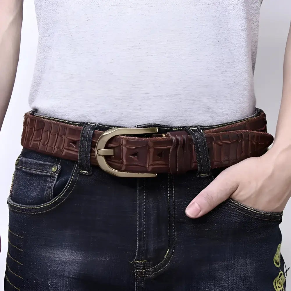 Leather belt with brass buckle showcasing quality craftsmanship and crocodile pattern design