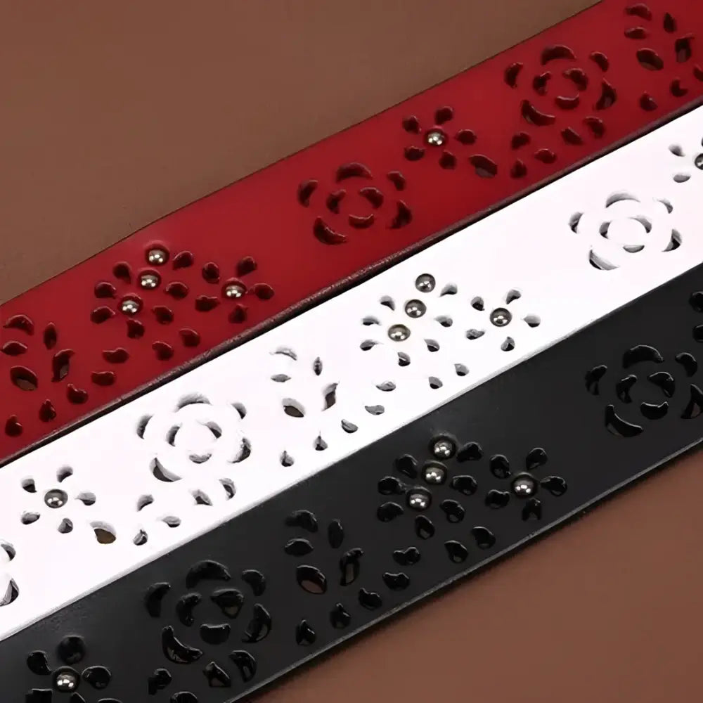 Three decorative leather belts with buckles and floral cutouts for stylish accessories