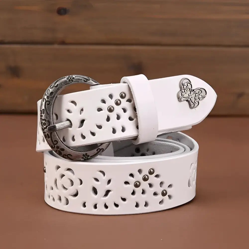White leather belt with floral cutouts and decorative buckle displayed in Leather Belts with Decorative Buckles and Floral Cutouts