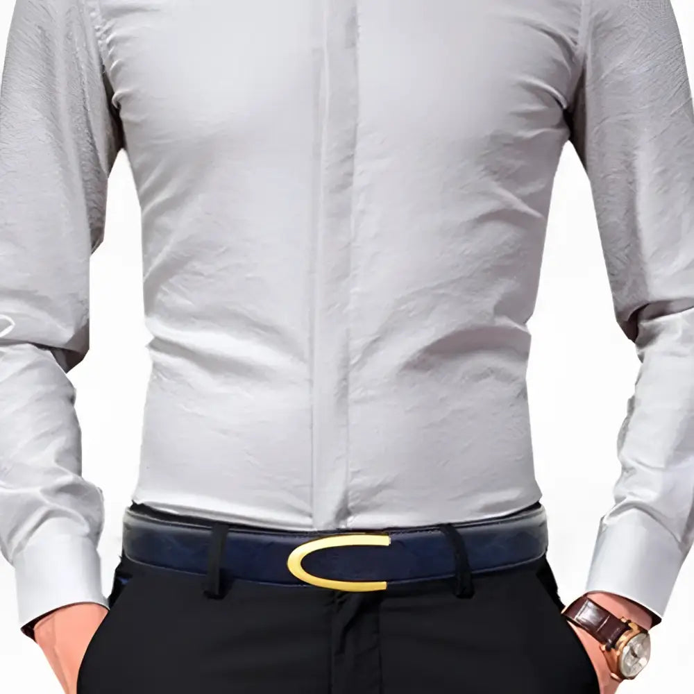 Gray dress shirt paired with a men’s leather belt in gray blue with gold and silver buckles