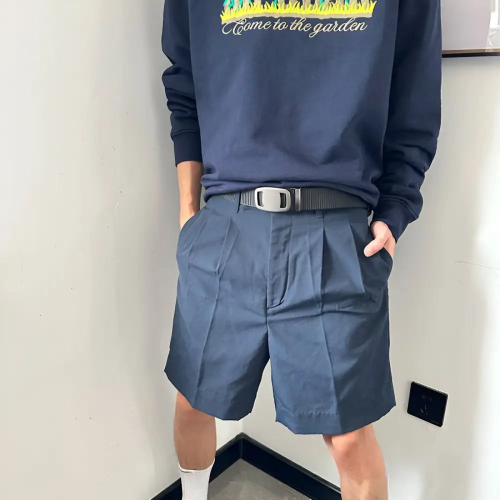 Navy Pleated Shorts featuring an automatic buckle and black nylon belt for a stylish look