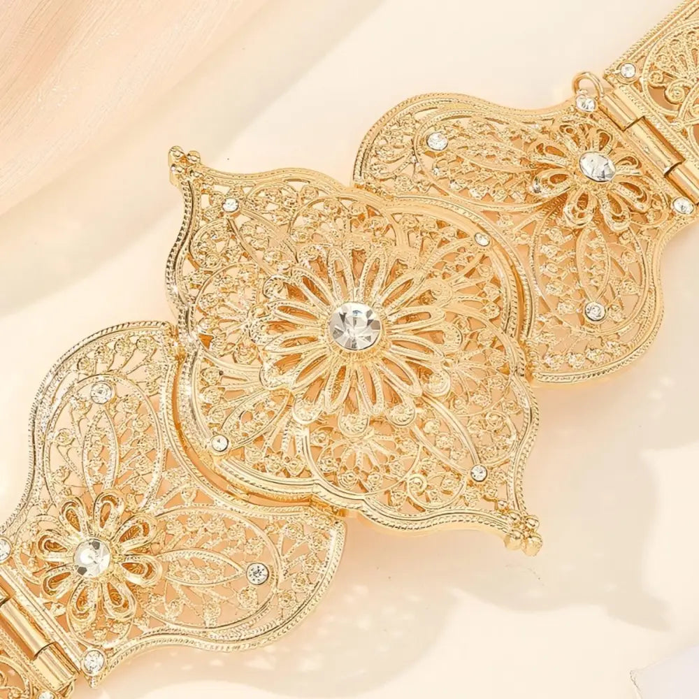 Ornate gold metal belt with intricate detailing suitable for formal wear