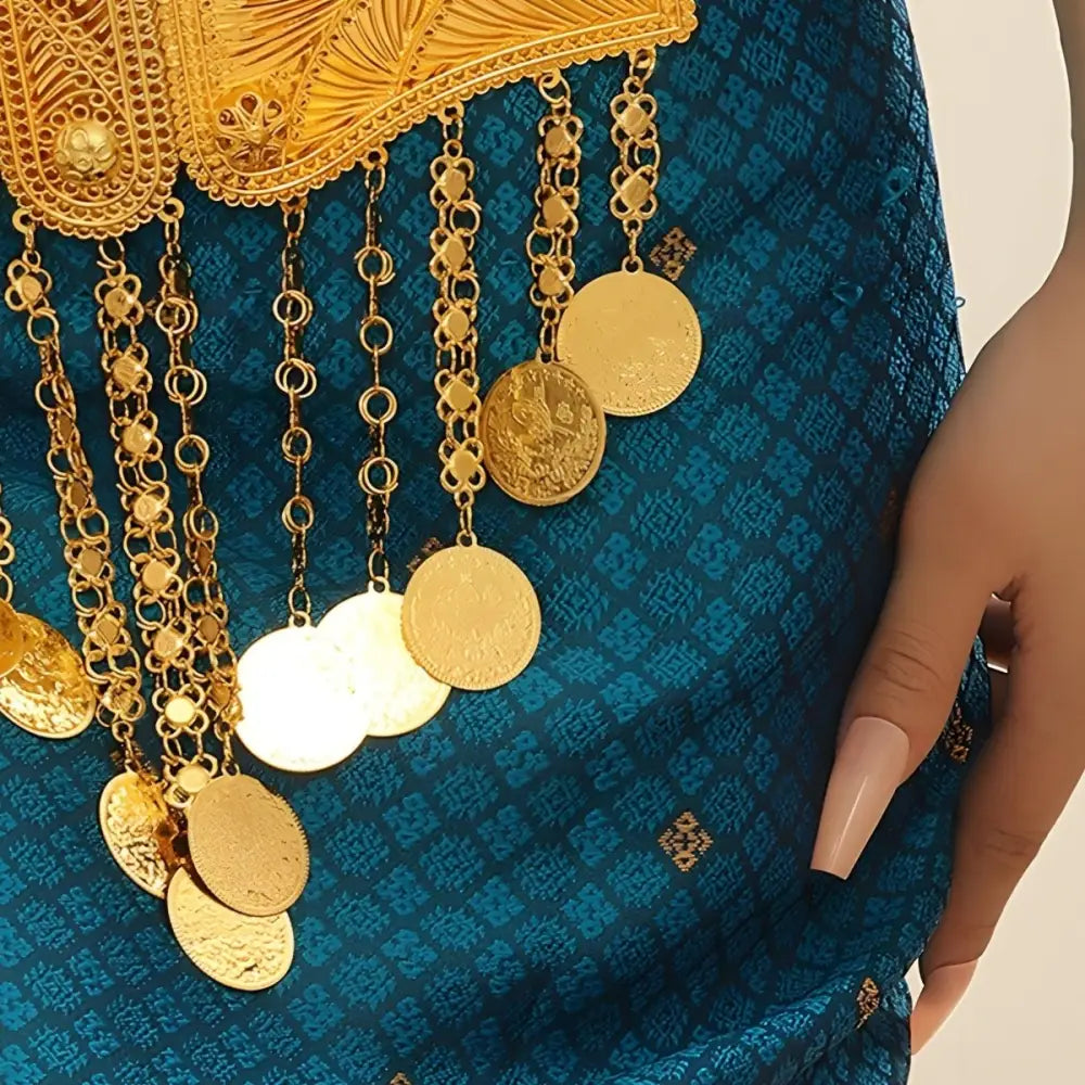 Ornate Gold Moroccan Belt with gold coin details on blue fabric for belly dance performance
