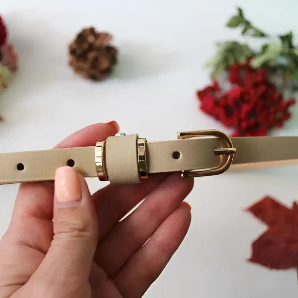 Beige Roxane Leather Belt with Gold Buckle complementing ribbed beige choker-neck sweater