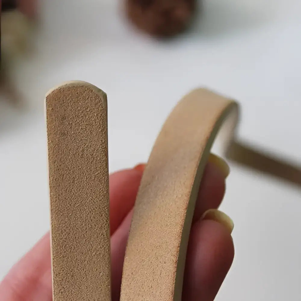 Tan suede-like bracelets paired with Roxane Leather Belt and ribbed beige choker sweater