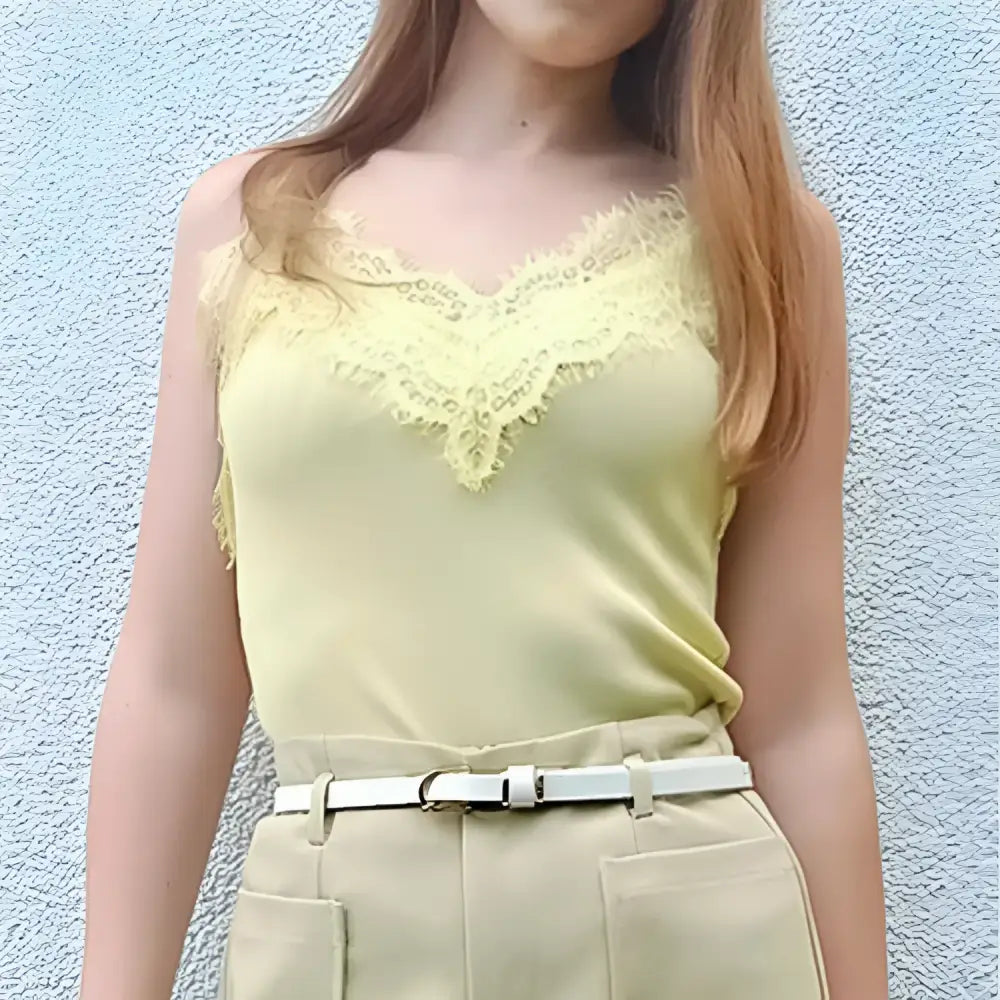 Yellow lace-trimmed camisole styled with Roxane Leather Belt and beige choker-neck sweater