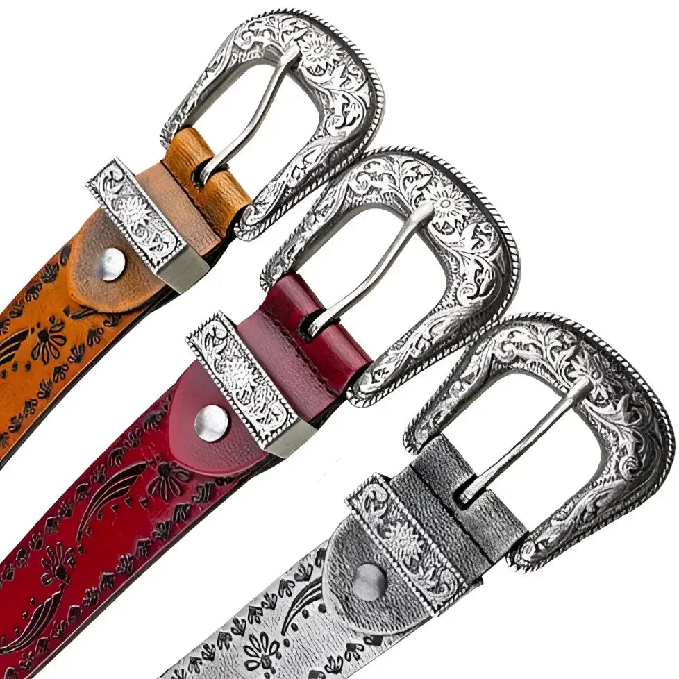 Set of three embossed leather belts with ornate silver buckles displayed prominently