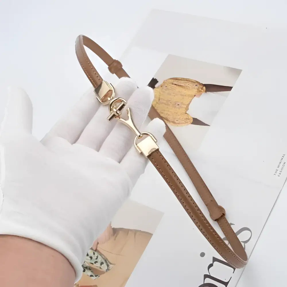 Shaqi Model Belt featuring a brown leather strap with decorative gold buckle