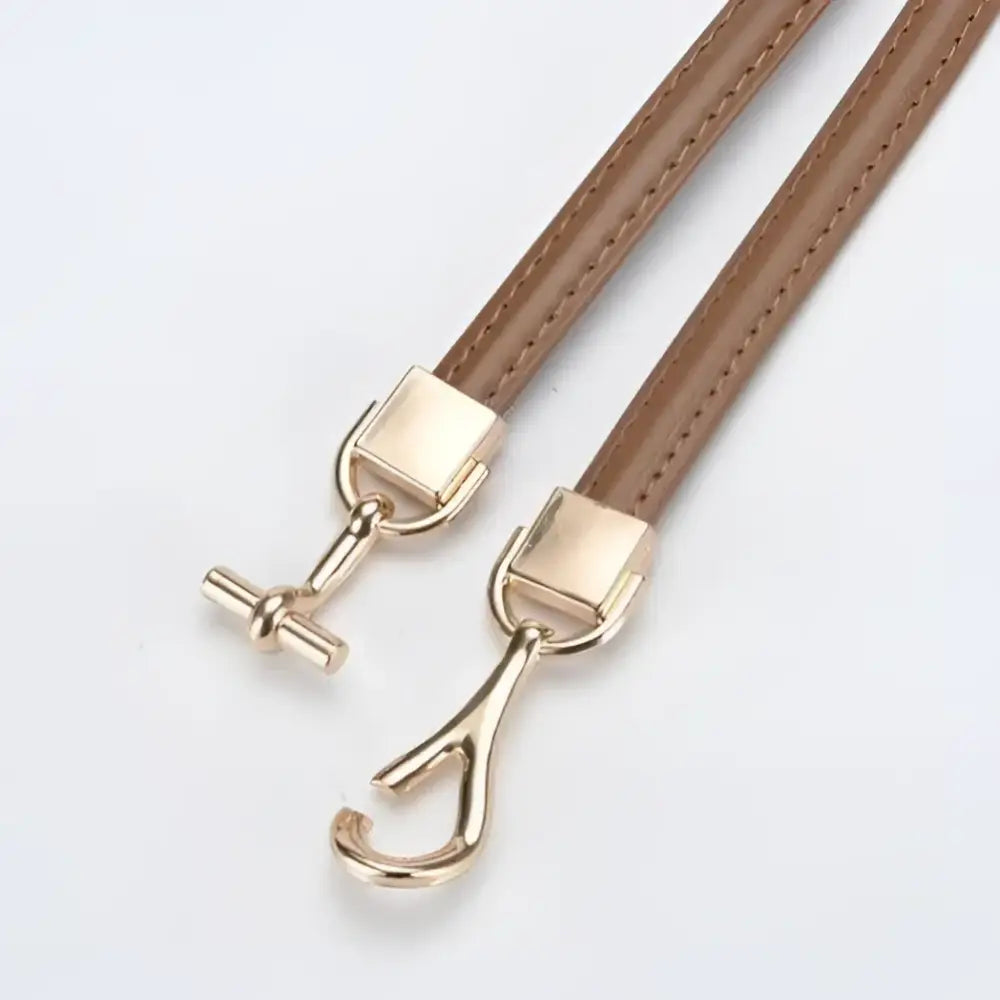 Tan leather straps with gold-toned metal clasps on Shaqi Model Belt thin leather accessory