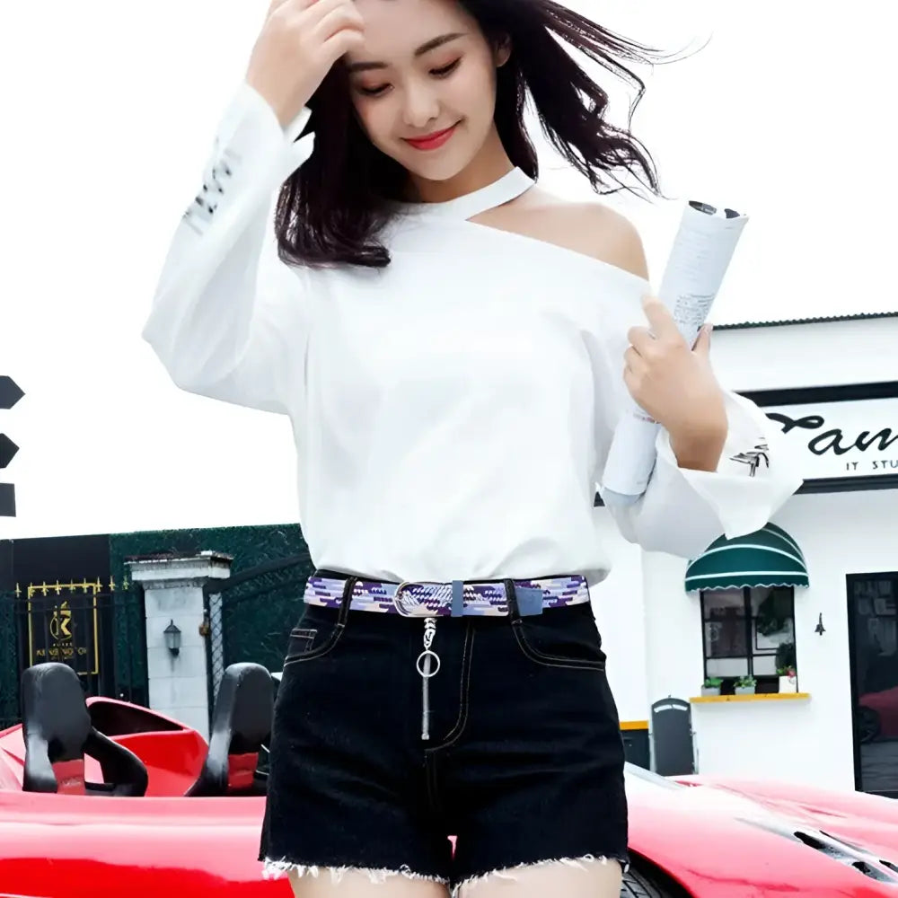 Woman wearing white off-shoulder top and black denim shorts with Silvana women’s elastic braided patterned belt for casual wear