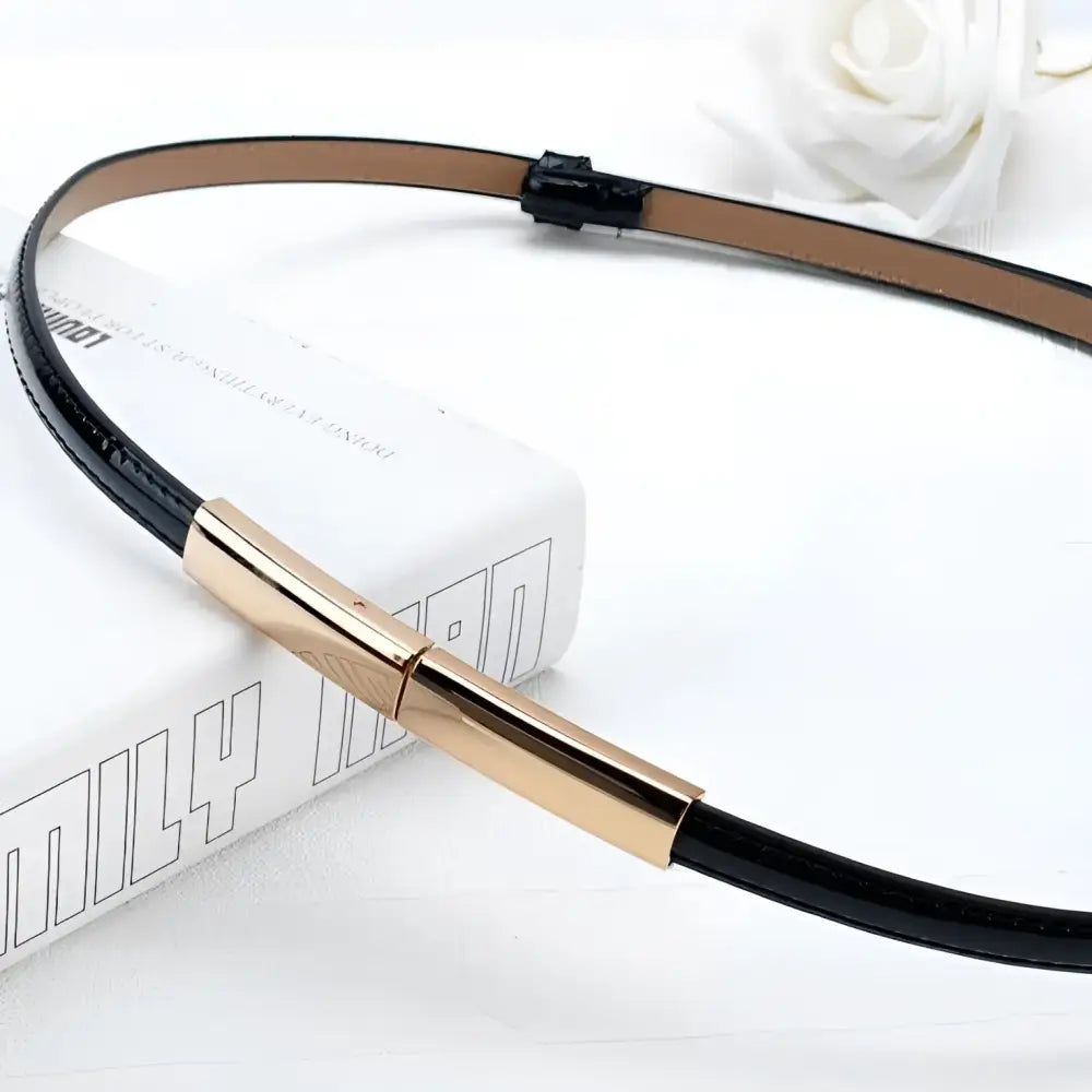 Black leather belt with a gold buckle from the Stacked Patent Leather Belts collection