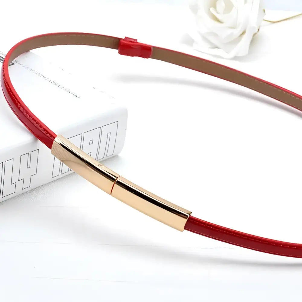 Red leather belt with gold buckle from the Stacked Patent Leather Belts collection