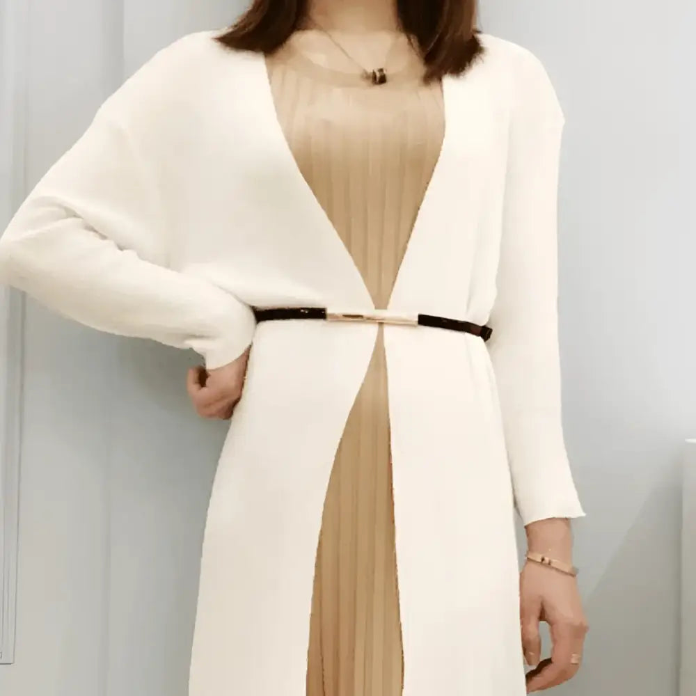 Woman wearing a white cardigan with a black and gold belt from Stacked Patent Leather Belts collection