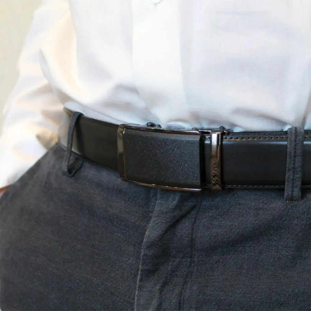 Black leather ratchet belt designed for formal attire showcasing sleek, adjustable fit