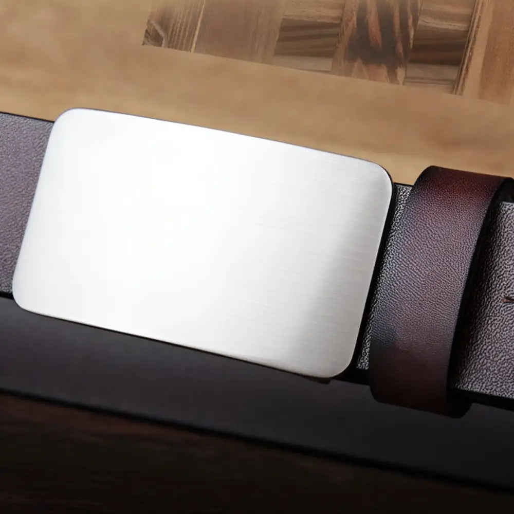 Silver belt buckle on brown full-grain leather belt ideal for sophisticated style