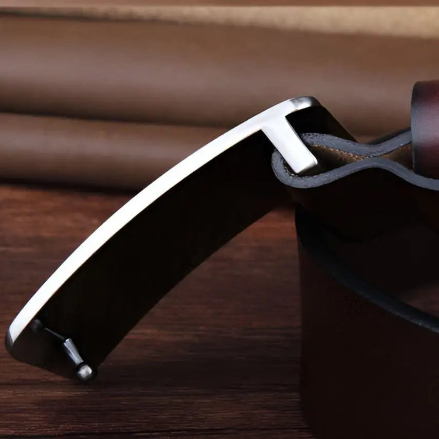 Silver belt buckle on brown full-grain leather strap of Black Full-Grain Leather Belt