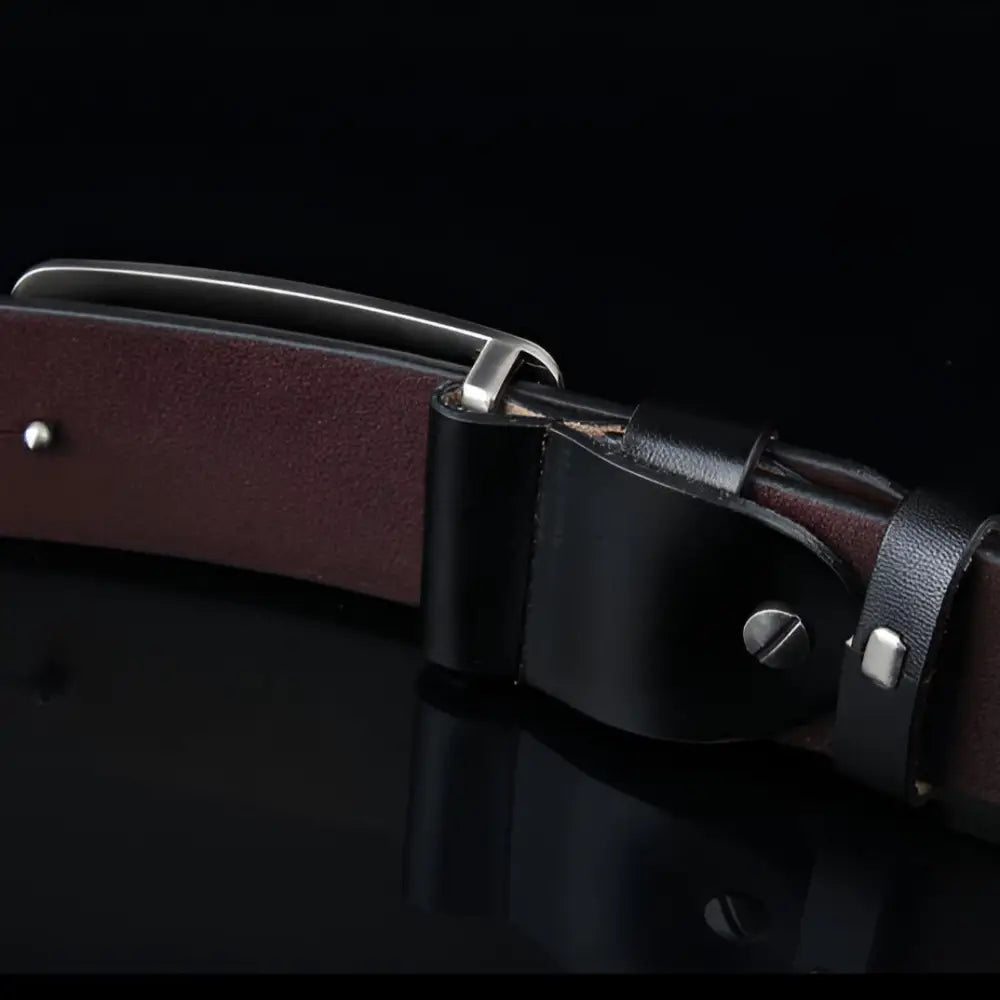 Black full-grain leather belt with silver metal buckle for premium fashion accessories