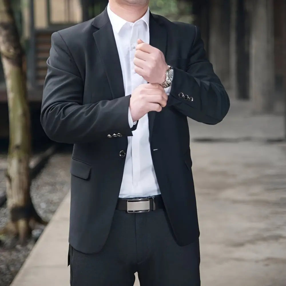 Man wearing a black grain leather belt with silver buckle, ideal for formal attire