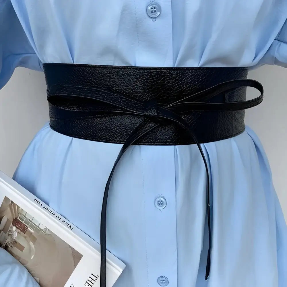 Black leather obi belt from the Velthuria Belt Collection displayed prominently